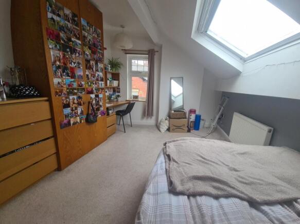 A bright and cozy master bedroom featuring a la...