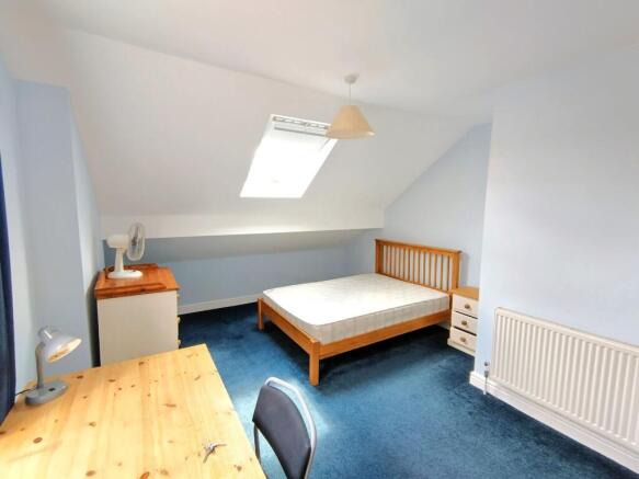Bright attic double bedroom with a skylight, wo...
