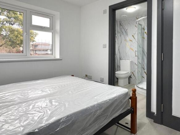 Bright, simply furnished double bedroom with a ...