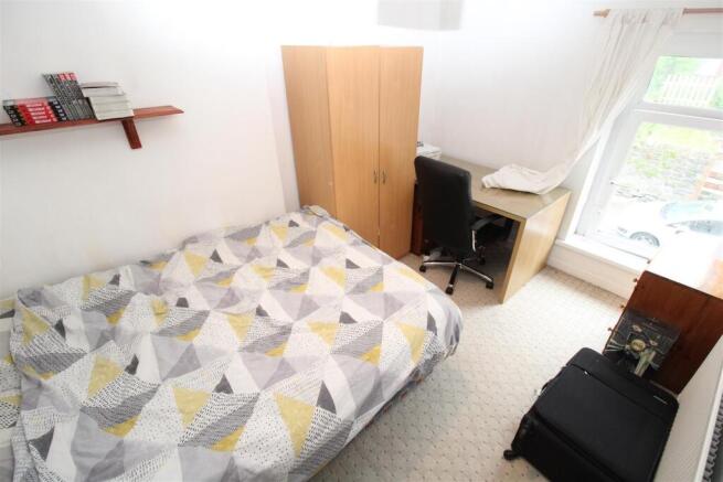 Bright bedroom with double bed and desk area...