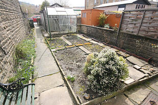 Garden with garage beyond