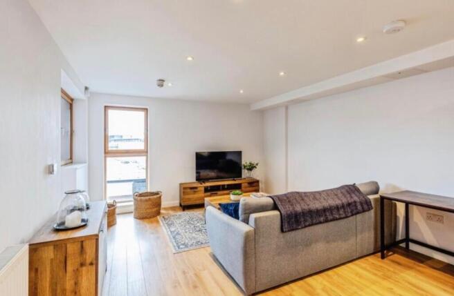 Bright, modern living room with wood flooring, ...