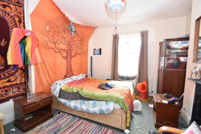 Bright, colorful double bedroom with a double b...