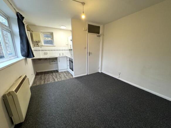 Well-lit studio room featuring a compact fitted...