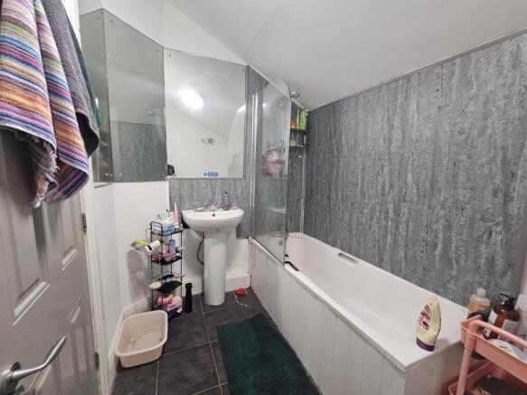 A clean and modern bathroom featuring a bathtub...