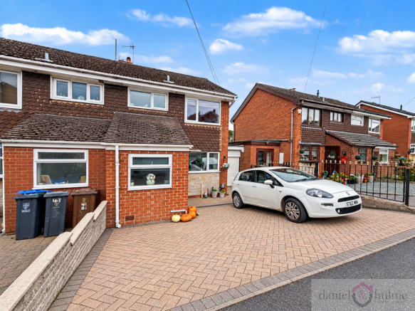 Pristine UK Driveway with White Hatchback