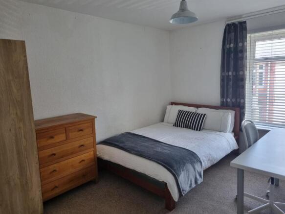Bright master bedroom with ample storage space...