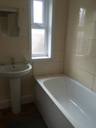 Bright bathroom suite featuring a clean white b...