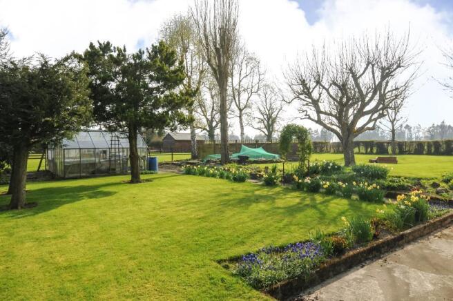 Garden with greenhouse and mature trees