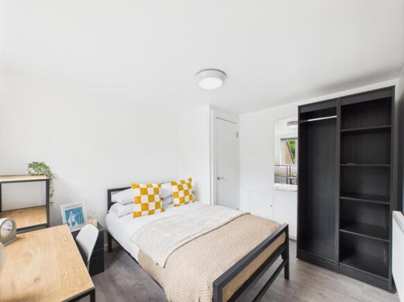 Bright, modern bedroom with a double bed, neutr...
