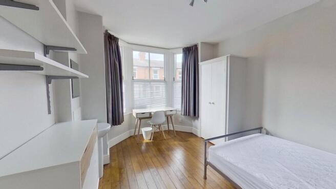 Bright and airy bedroom featuring a comfortable...