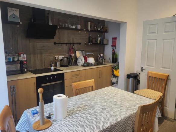 Well-equipped open kitchen with integrated oven...