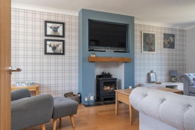 A log burner gives this room a cosy country feel