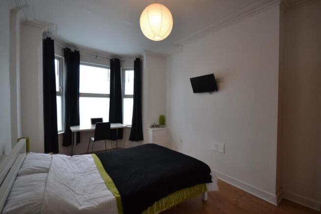 Bright bedroom with bay window and study desk...