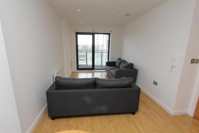 Modern living space with balcony and sleek sofa...