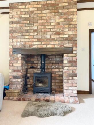 EXPOSED BRICK FIREPLACE WITH BURNER