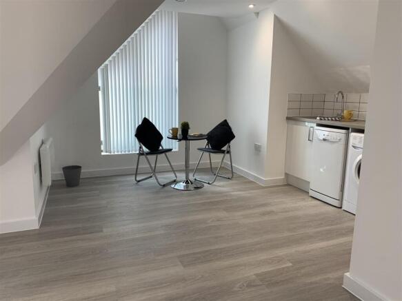 Bright open-plan living area with kitchenette...