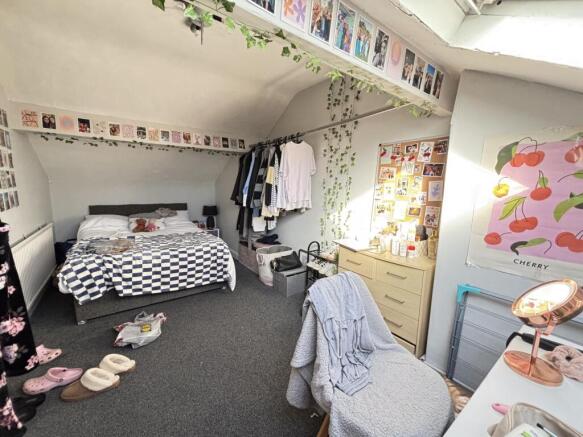 A cozy and bright bedroom with a comfortable be...