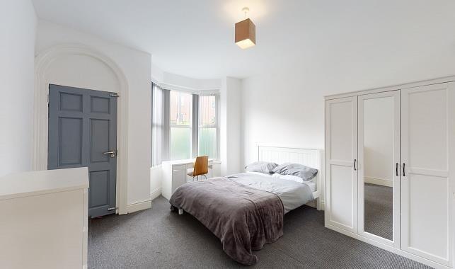 Bright, freshly decorated master bedroom with a...