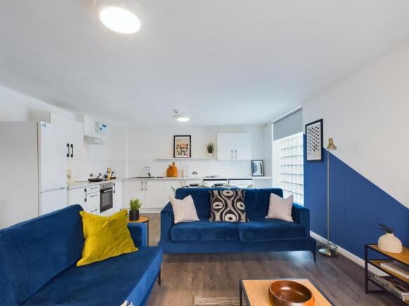 A bright and modern living room featuring two c...