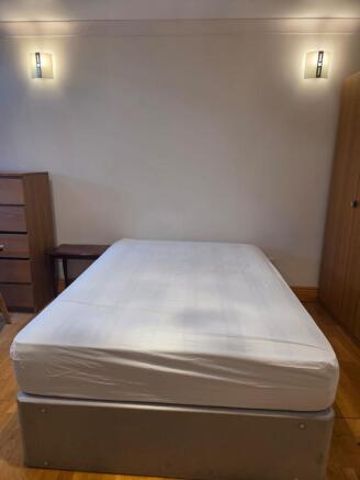 Cozy double bedroom with ample storage and ligh...