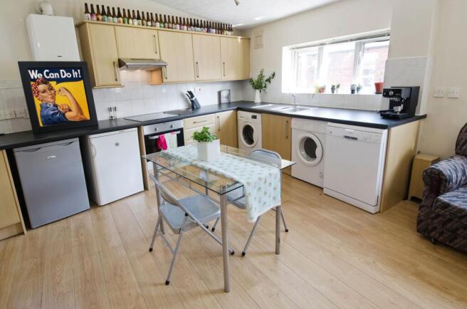 Bright, modern kitchen with light wood cabinets...