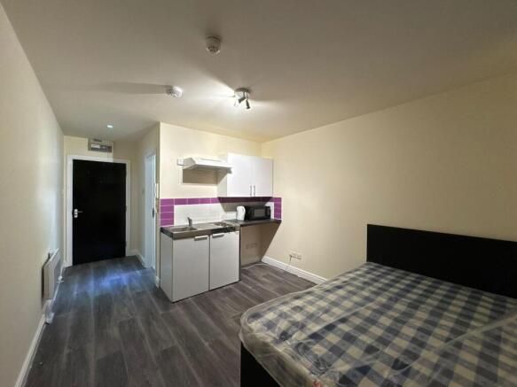 A well-lit, modern living area featuring a comf...