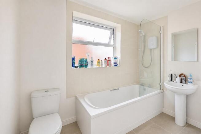Bright and airy bathroom with a full-size tub...