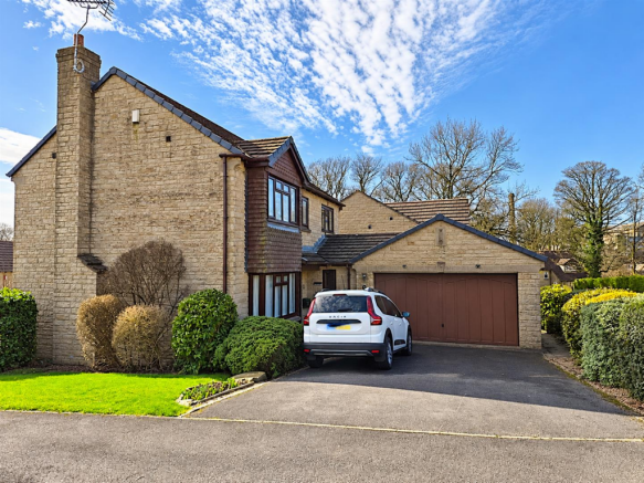 Suburban home under a blue sky.png