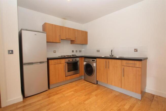 Bright kitchen with modern integrated appliance...