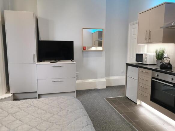 Modern studio kitchen with sleek appliances...