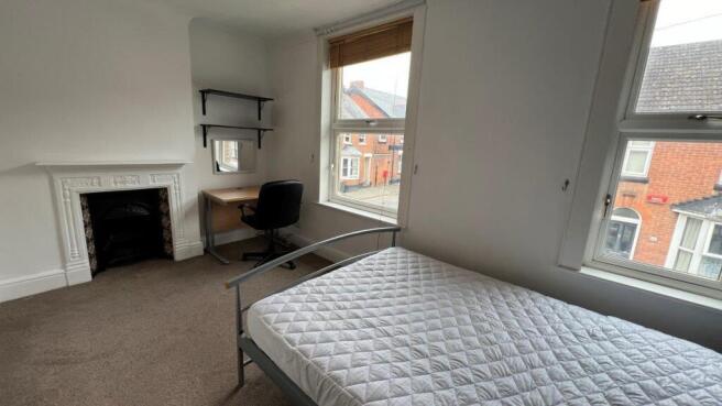 Bright bedroom with dual windows and study desk...