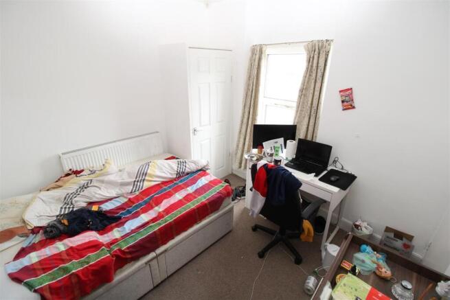 Bright bedroom with workspace and ample storage...