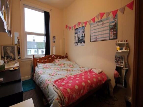 A comfortable double bedroom featuring a stylis...