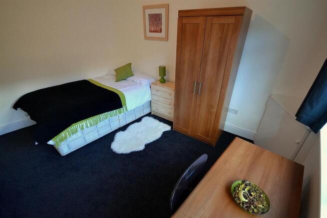 Bright bedroom with ample storage and desk...