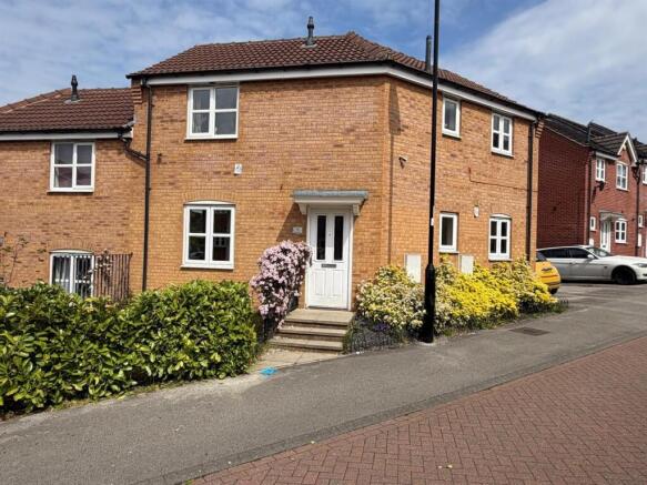Charming brick home with lush green gardens...