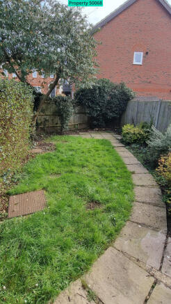 Garden with patio space at the end.