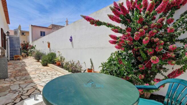 paved courtyard to front door