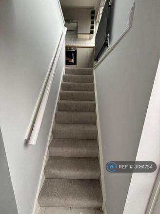 Entrance Looking Up The Stairs Into Kitchen