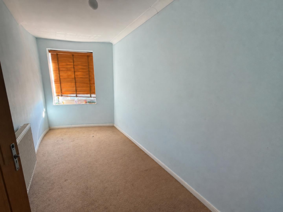 Empty Blue Bedroom with Wooden Blinds.png