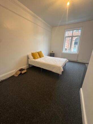 Bright, simply furnished double bedroom with a ...