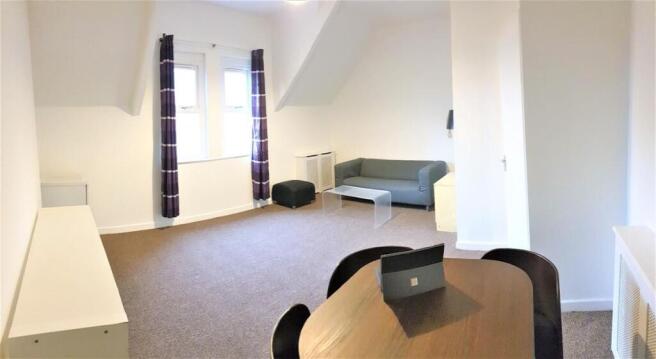 Bright, spacious living area with dining table...