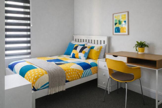 Bright, neatly styled single bedroom with a com...