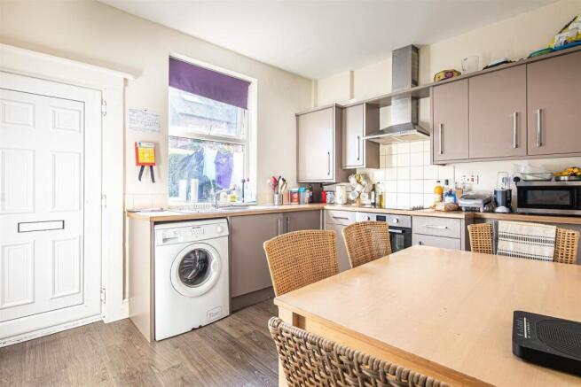 Bright kitchen with modern units and dining spa...