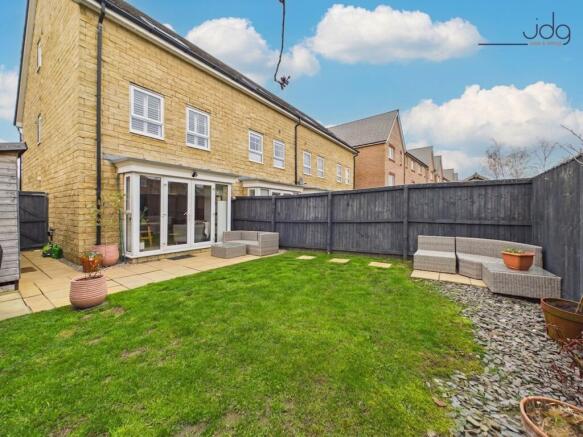 South-facing garden with a lawn and patio