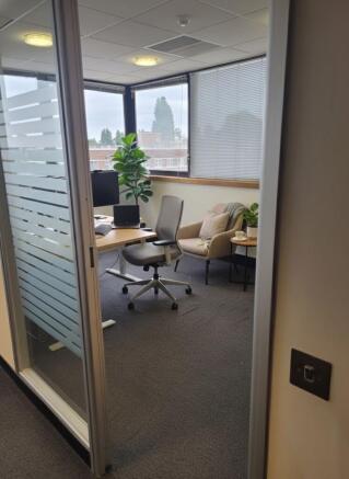 Bright corner workspace with large windows, erg...
