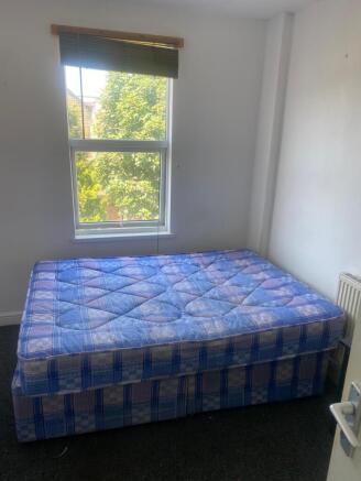 Bright bedroom with a large window overlooking ...