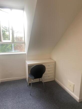 Bright small bedroom nook with a sloped ceiling...