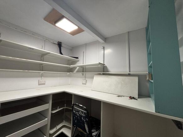 Bright study area with extensive shelving stora...
