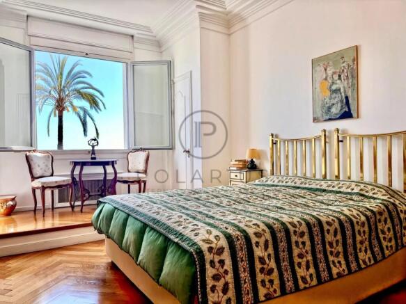 Bright and spacious bedroom featuring a large wind